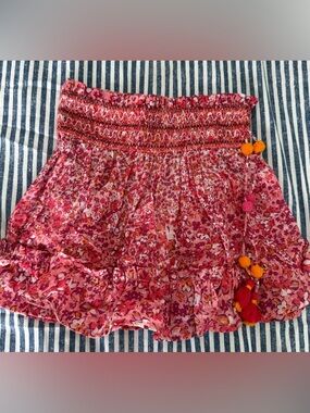 Poupette St. Barth Irma Pink Floral Smocked Mini Skirt with Tassel Pom-Poms